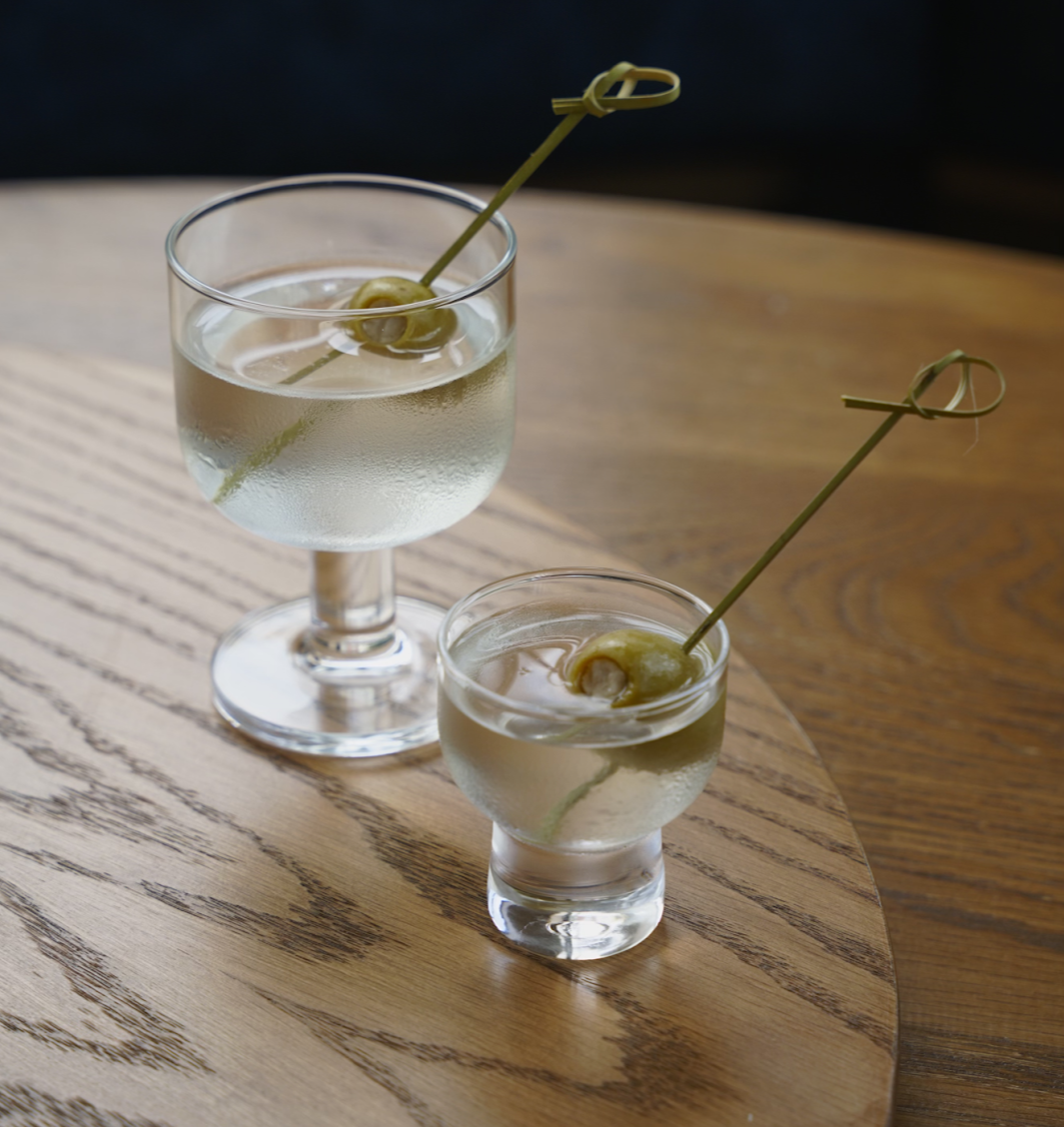 a glass of wine sitting on top of a table