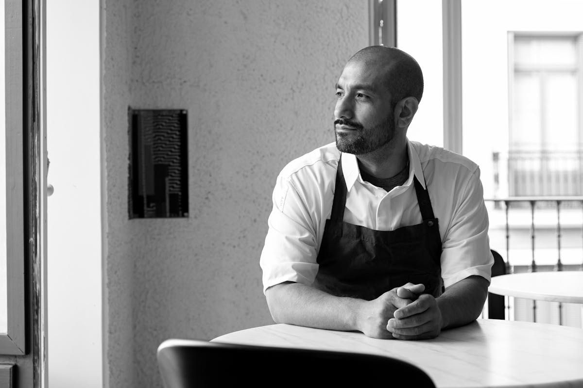 a man sitting at a table in front of a window
