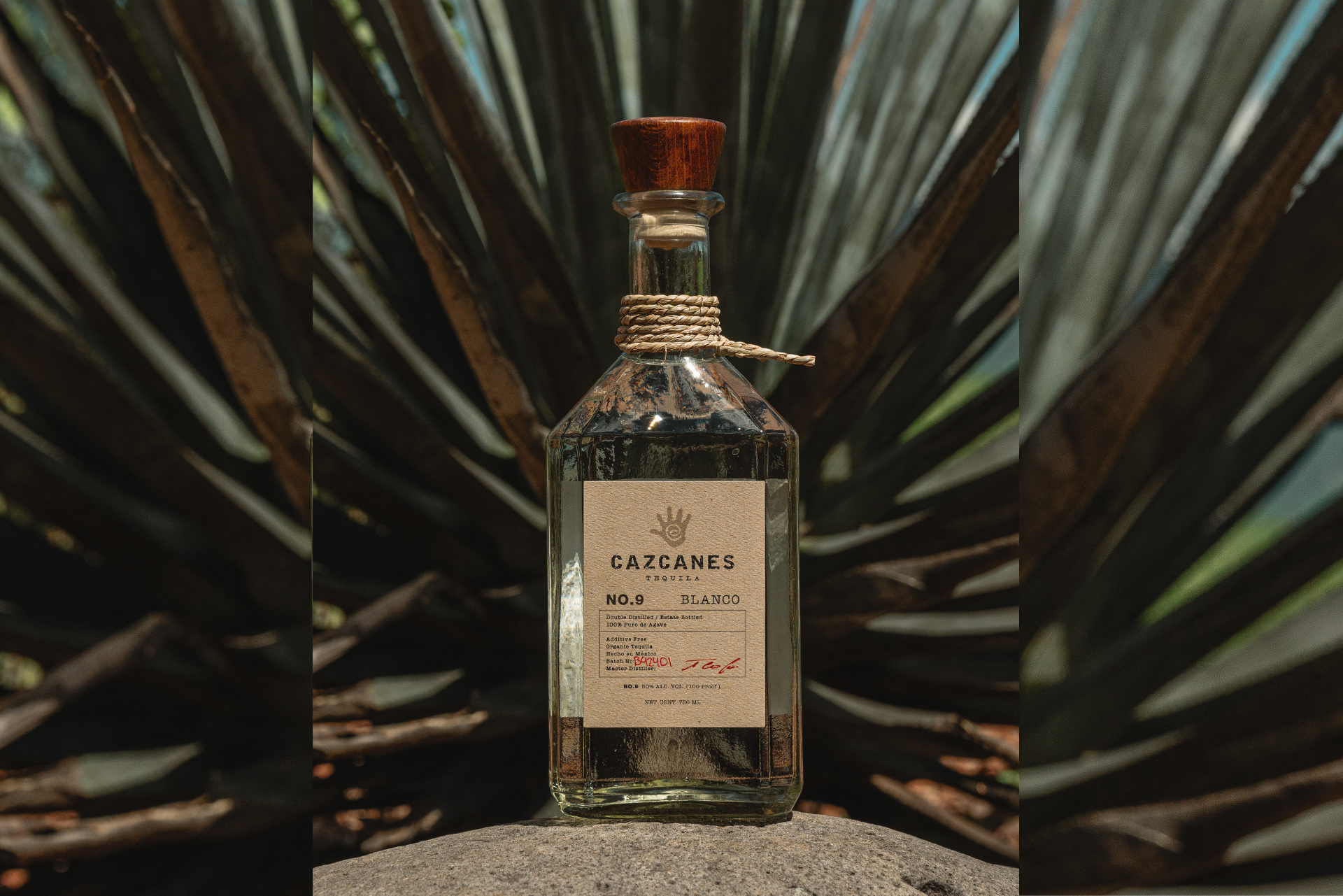 a bottle of alcohol on a rock