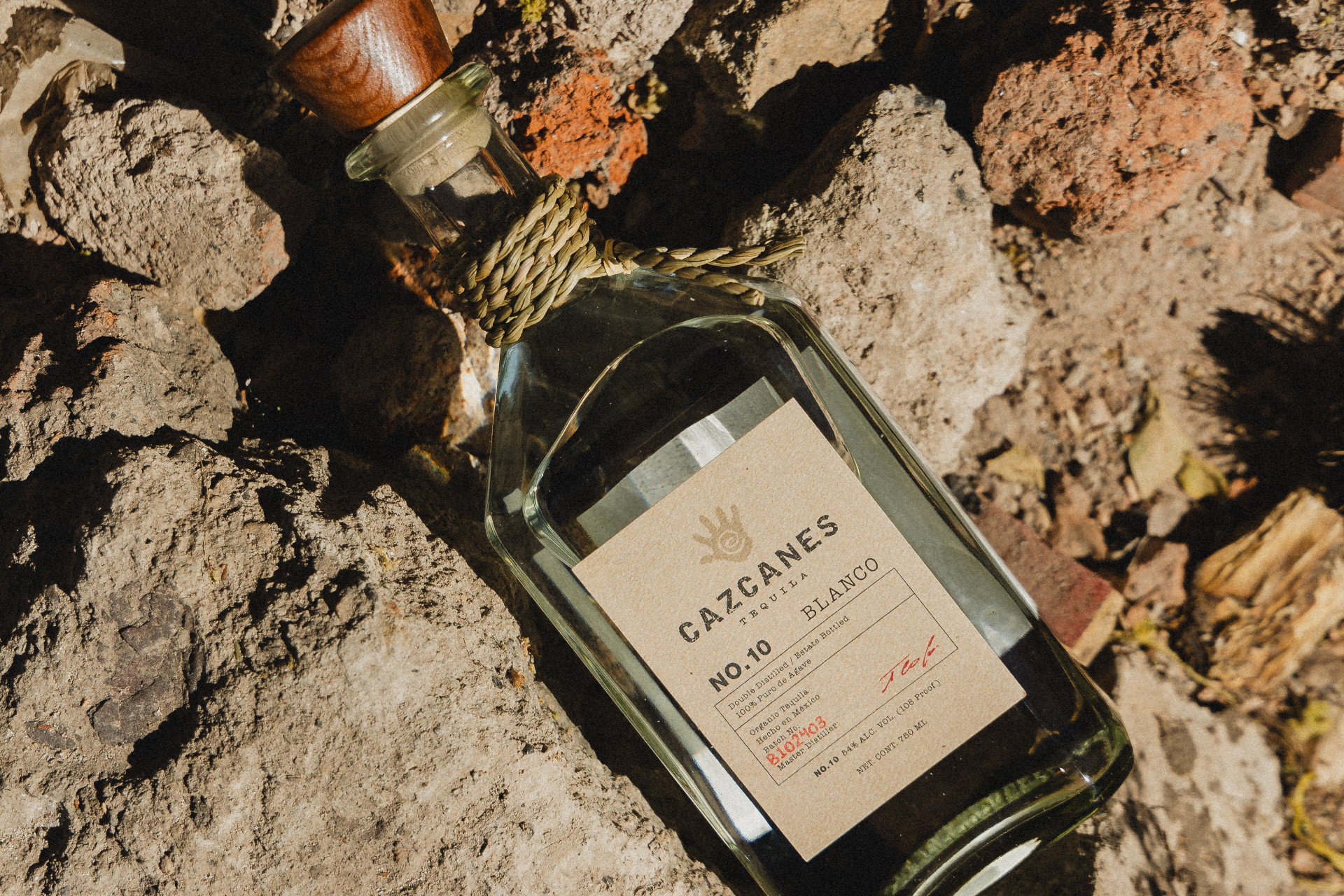 a bottle of alcohol on rocks