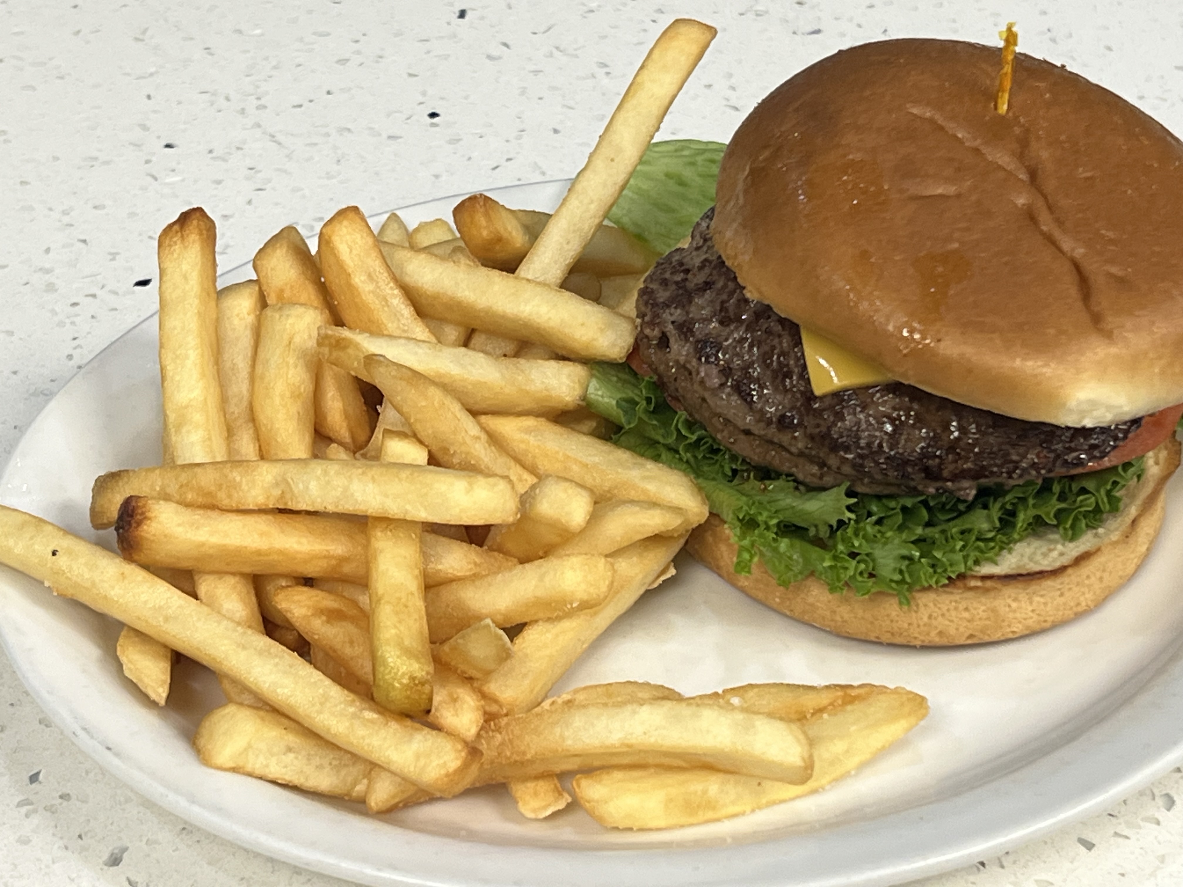 a sandwich sitting on top of a pile of fries