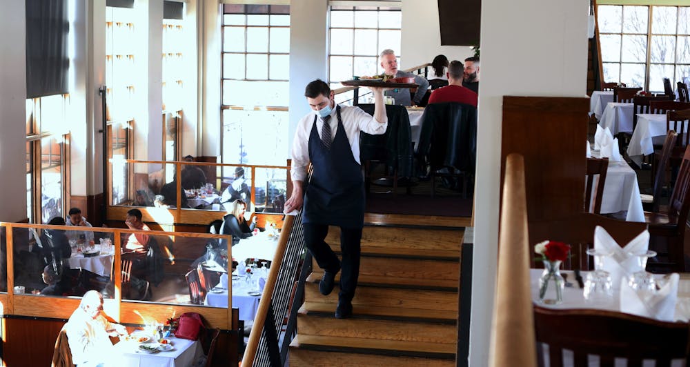 a group of people sitting at a table in front of a building