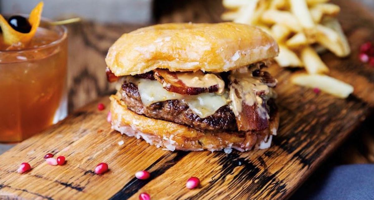 a close up of a sandwich sitting on top of a wooden cutting board
