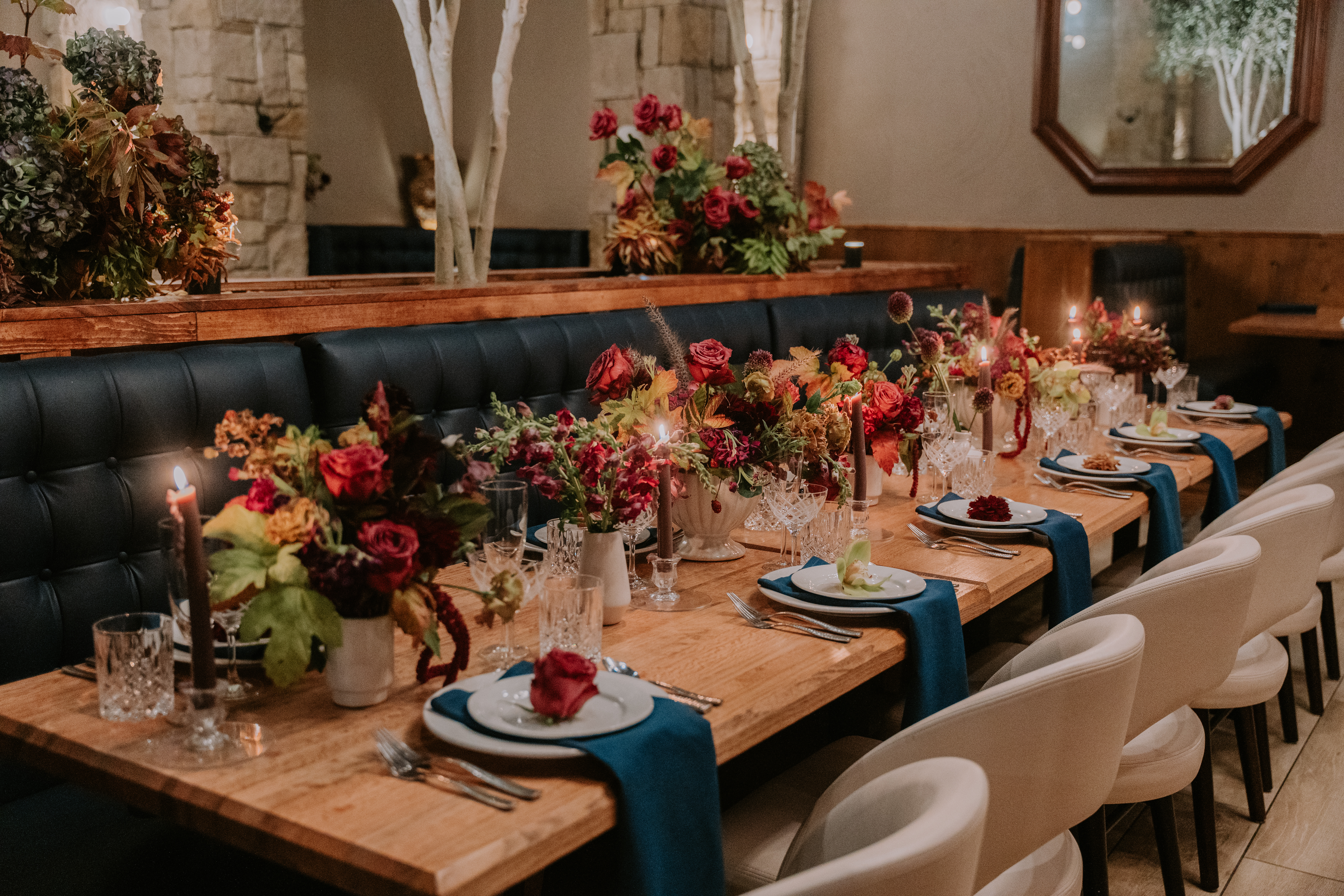 a living room filled with furniture and vase of flowers on a table
