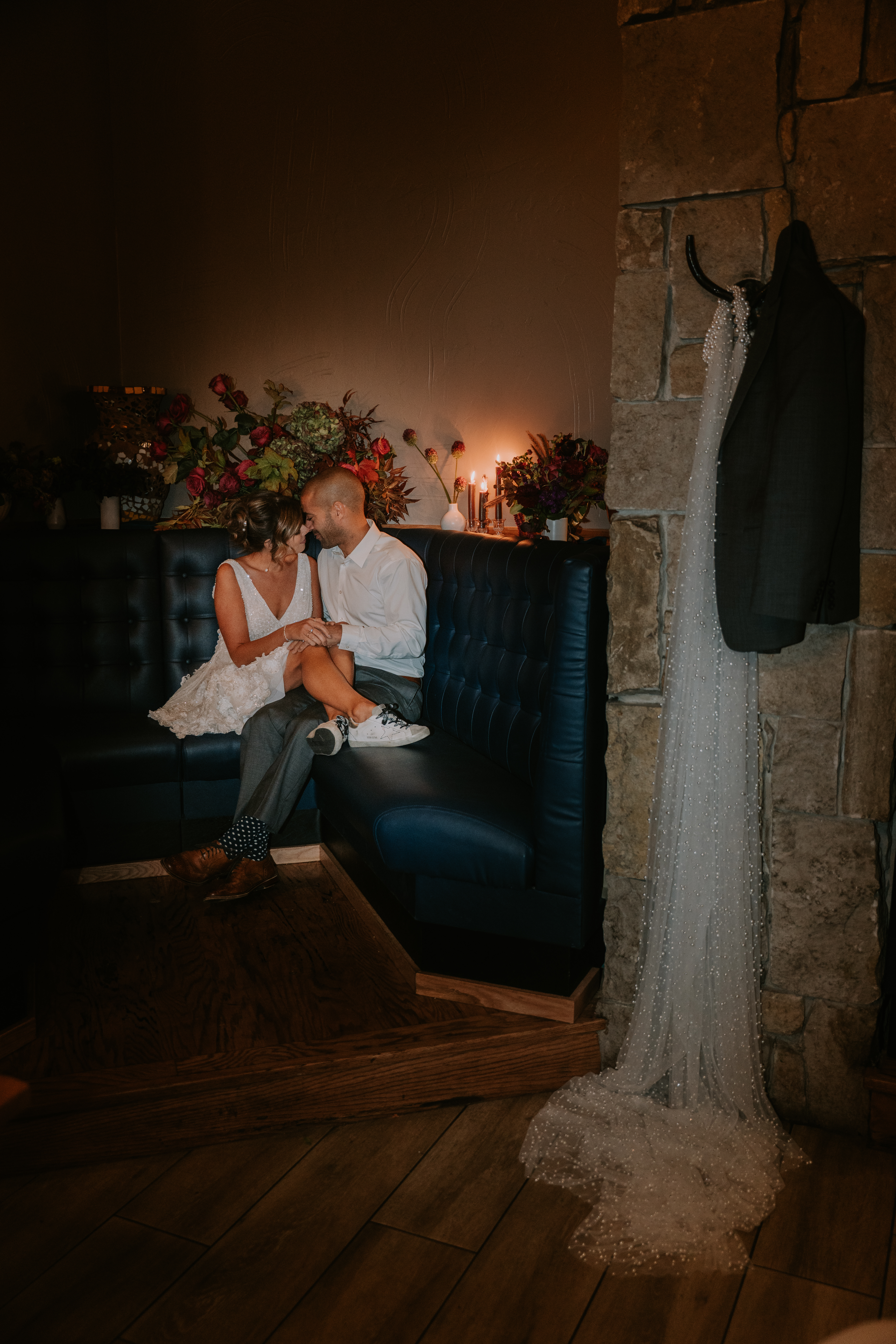 a man and woman sitting next to a fireplace