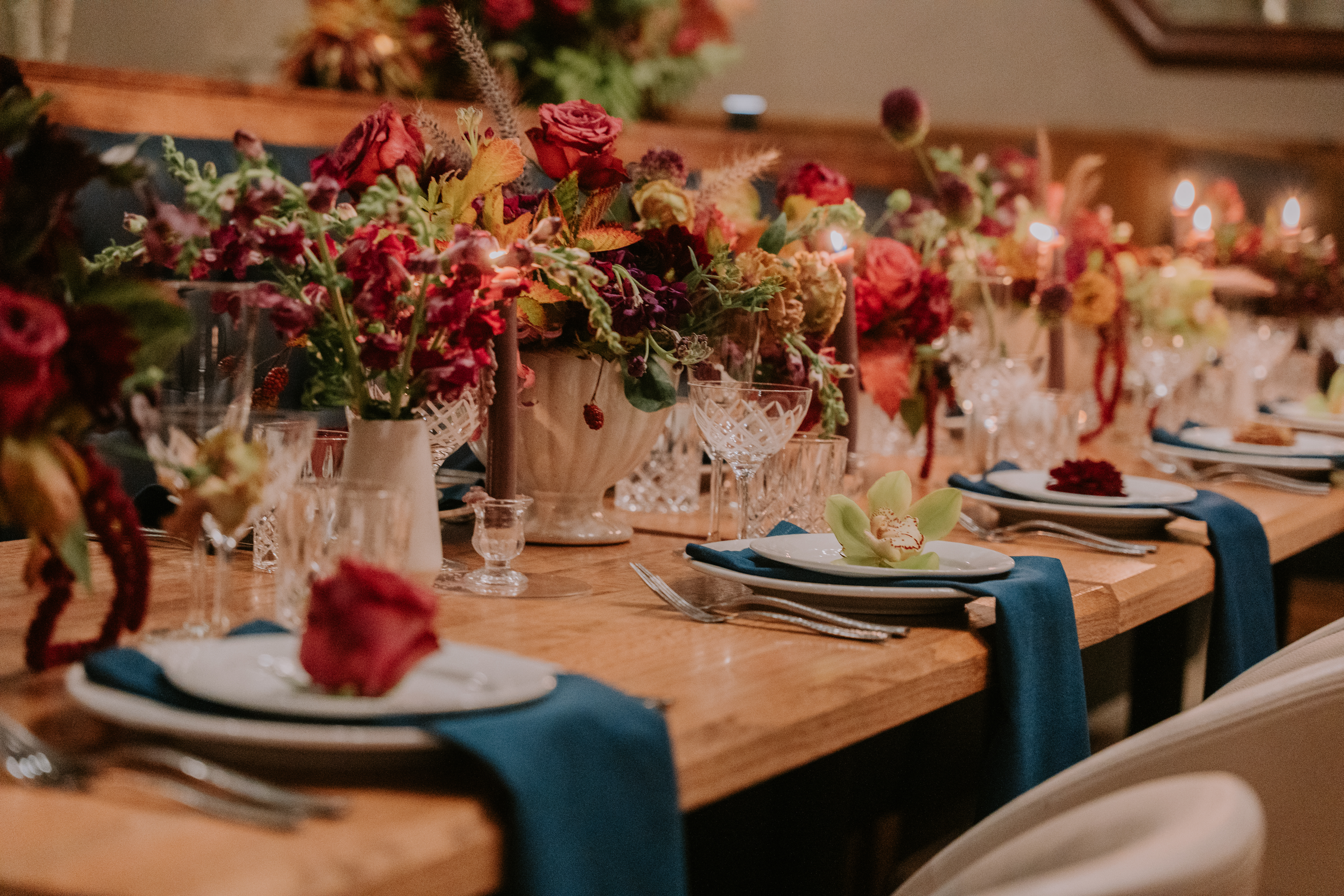 a room filled with furniture and vase of flowers on a table
