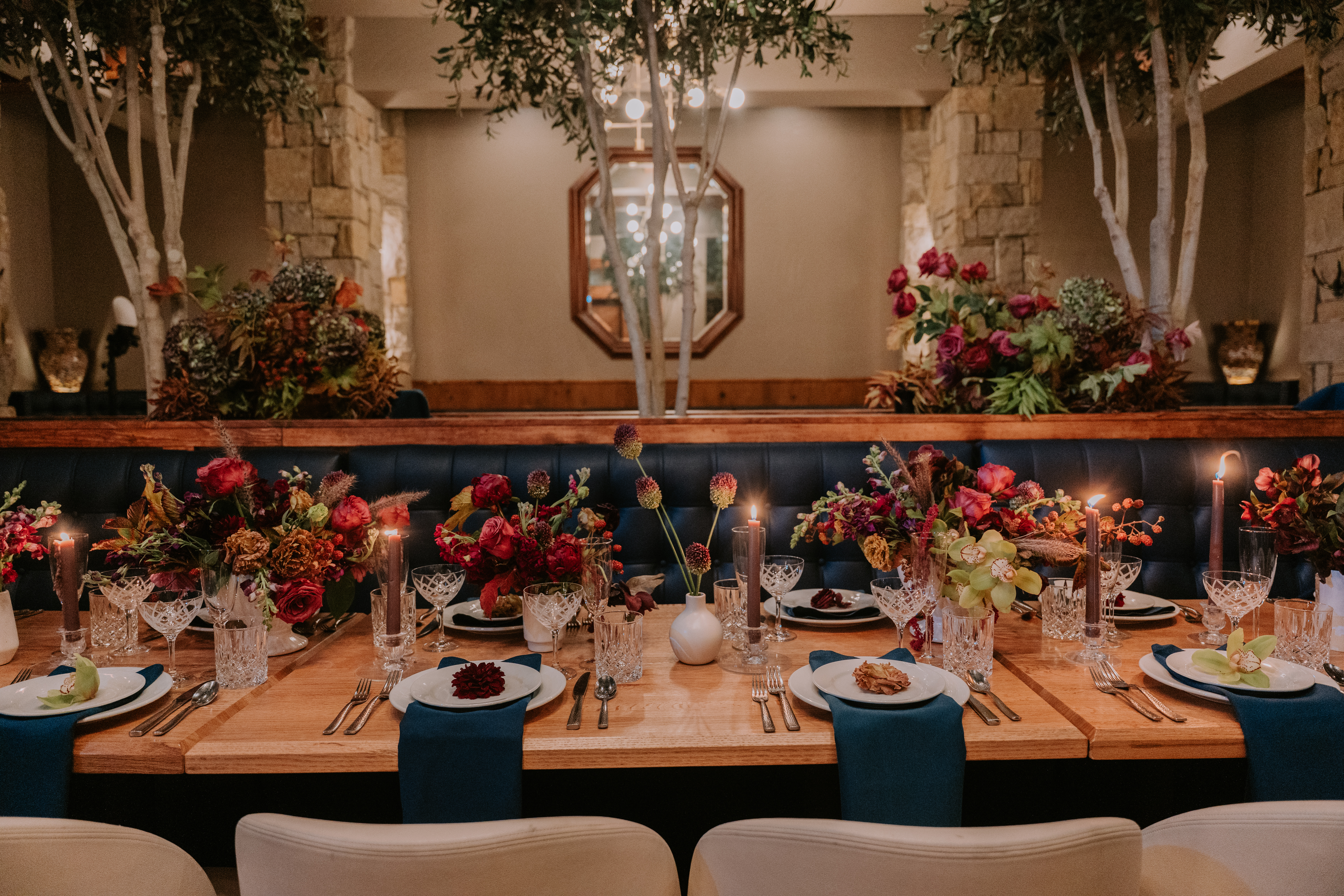 a room filled with furniture and vase of flowers on a table