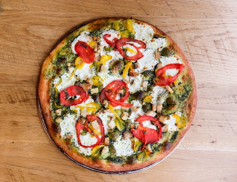 a pizza sitting on top of a wooden cutting board