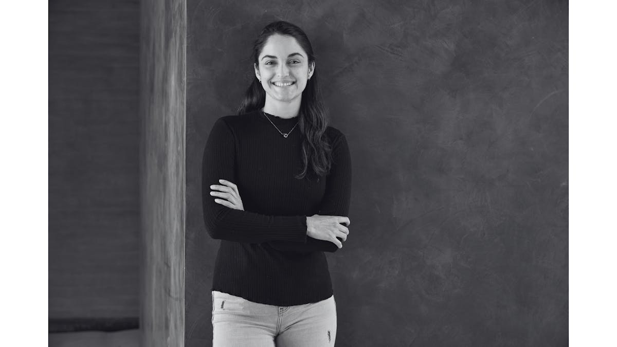 a woman standing in front of a wall
