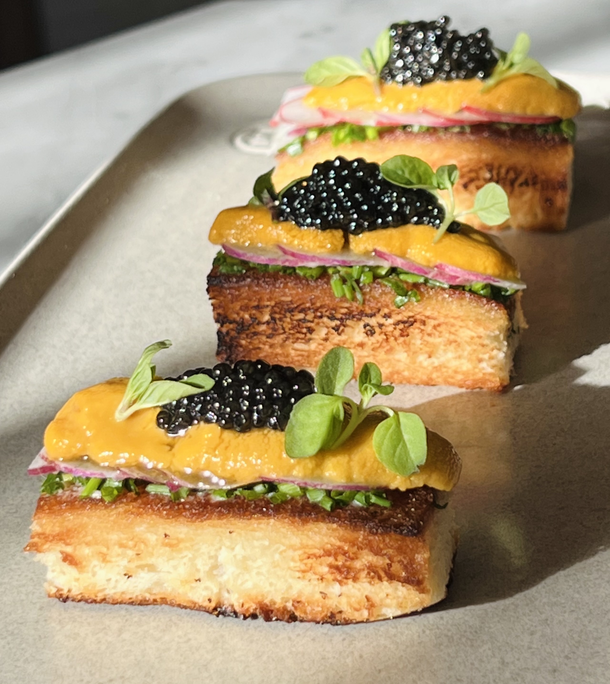 a sandwich sitting on top of a piece of cake on a table