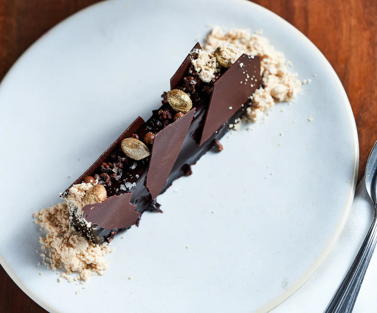 a half eaten piece of chocolate cake on a plate