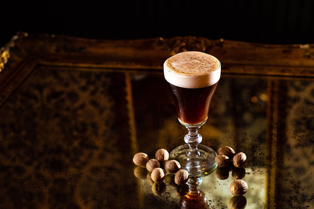 a close up of a wine glass sitting on a table