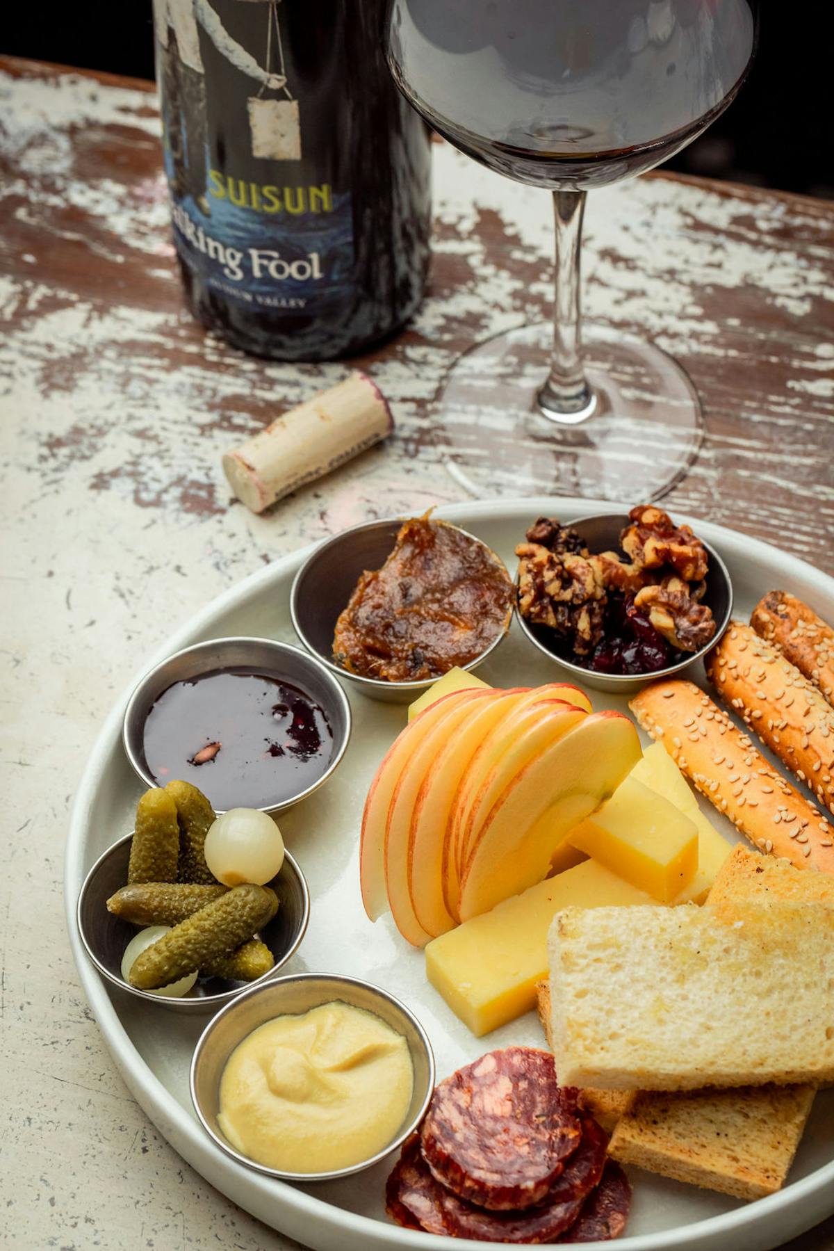 a plate of food and a glass of wine