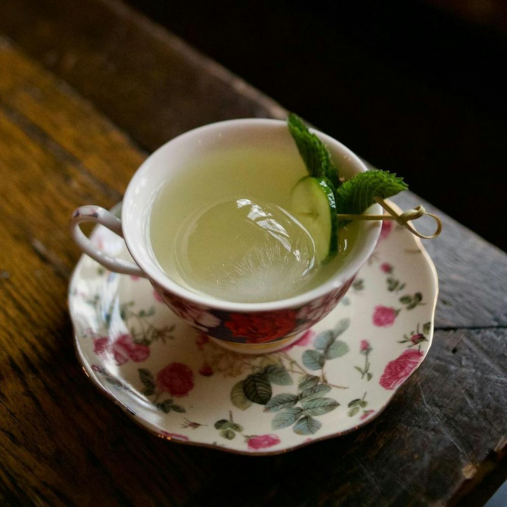 a cup of coffee sitting on top of a wooden table