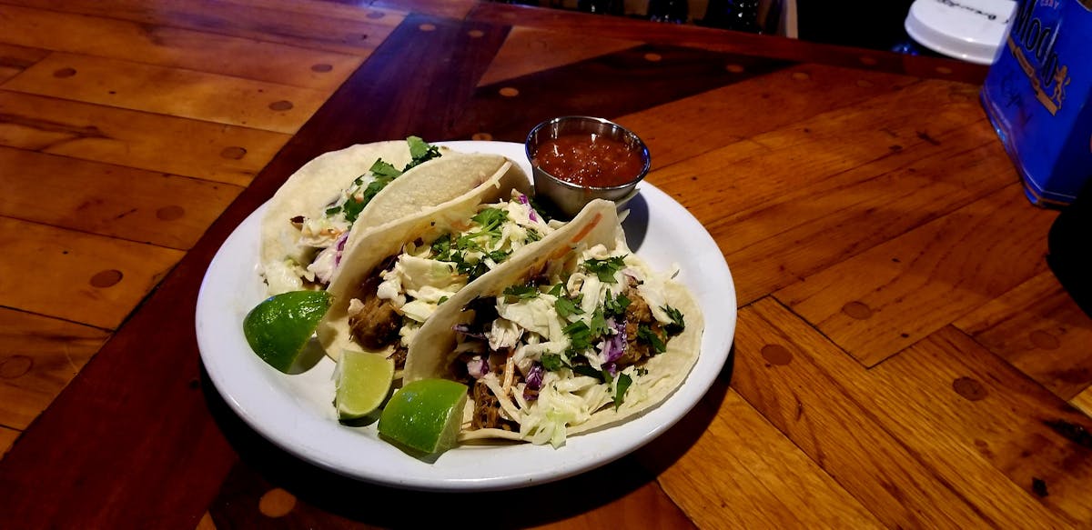 a plate of food sitting on top of a wooden table