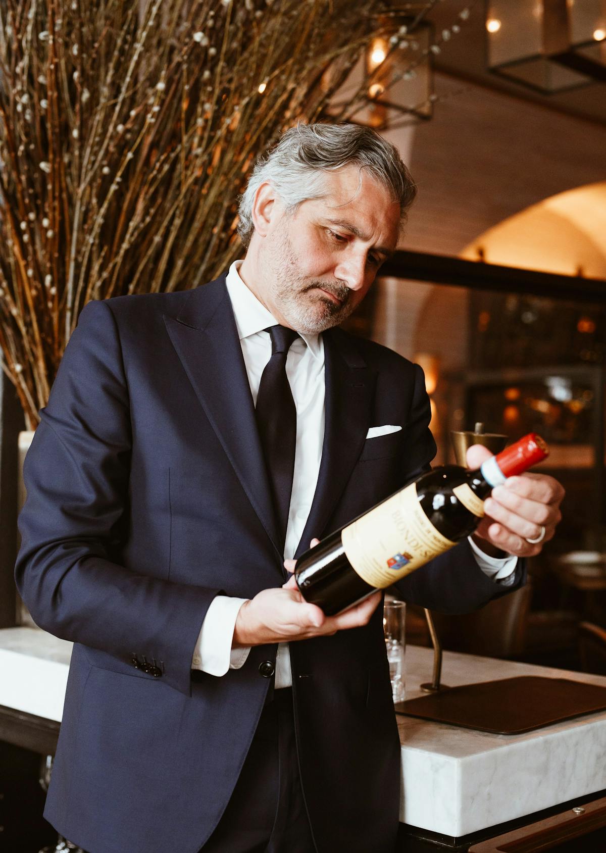 a man holding a bottle of wine