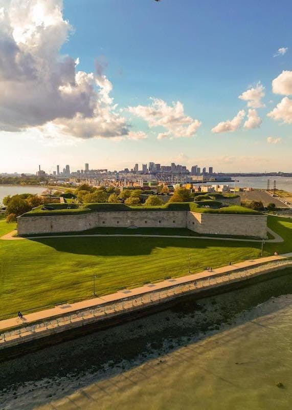 a train traveling down train tracks next to a body of water