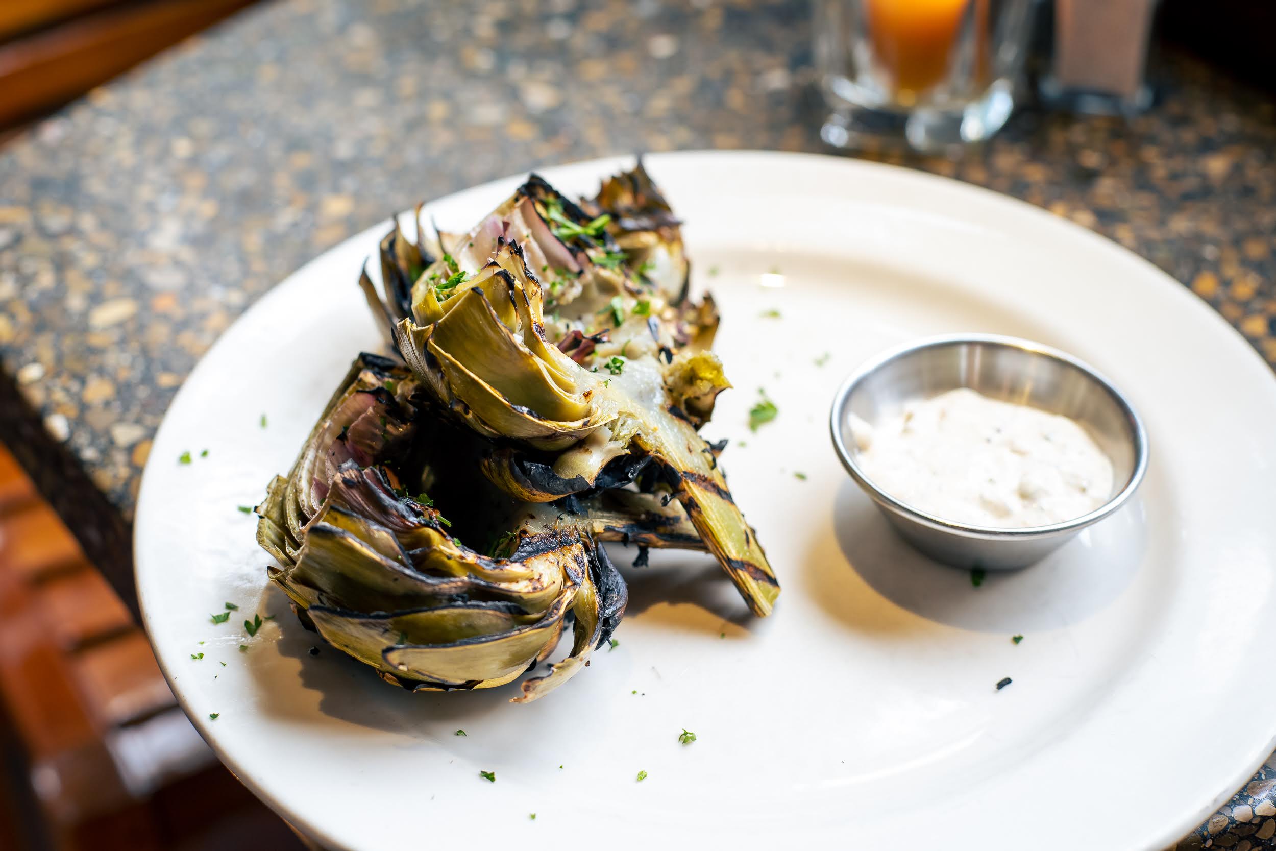 a plate of artichokes with sauce