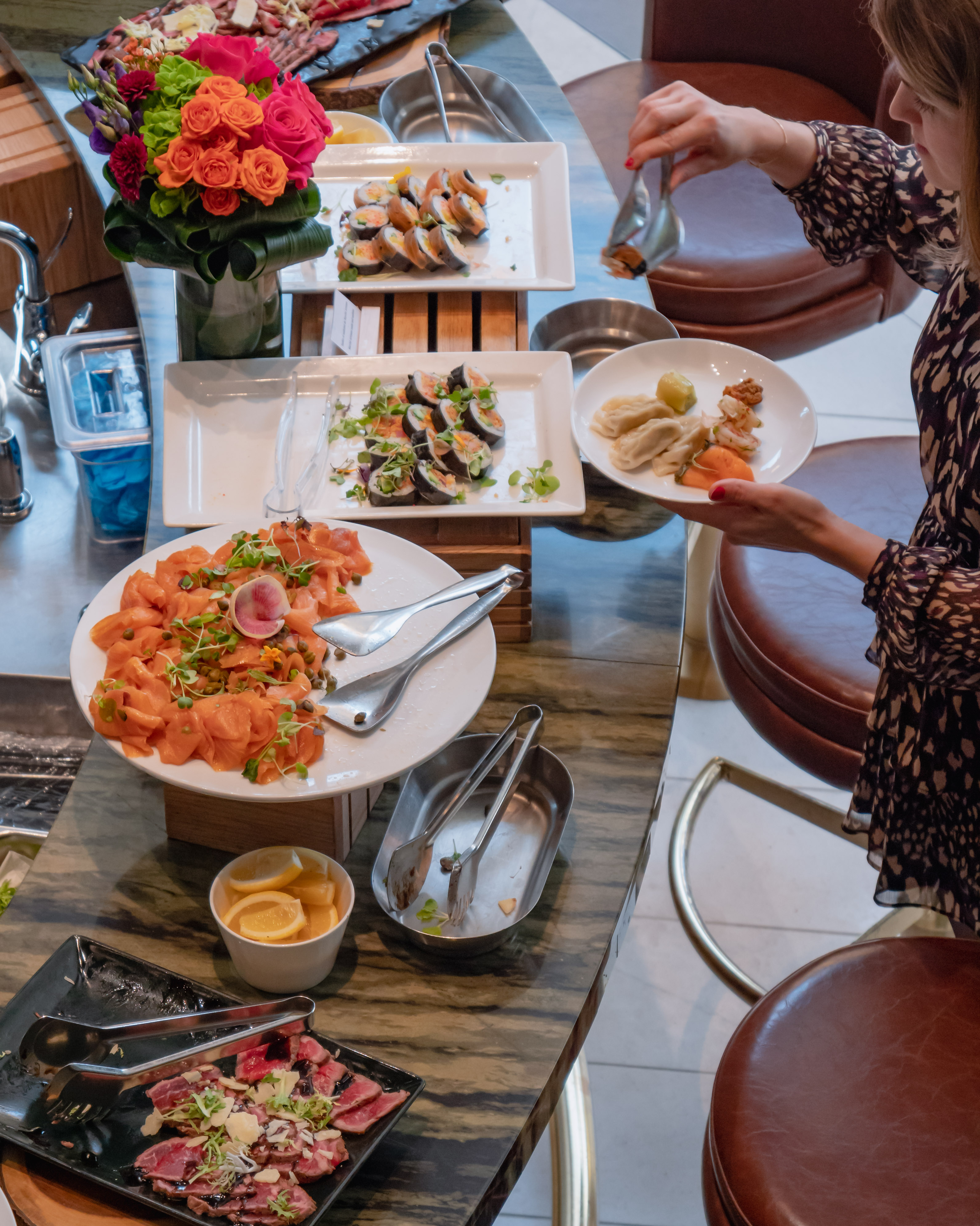 a woman sitting at a table with a plate of food