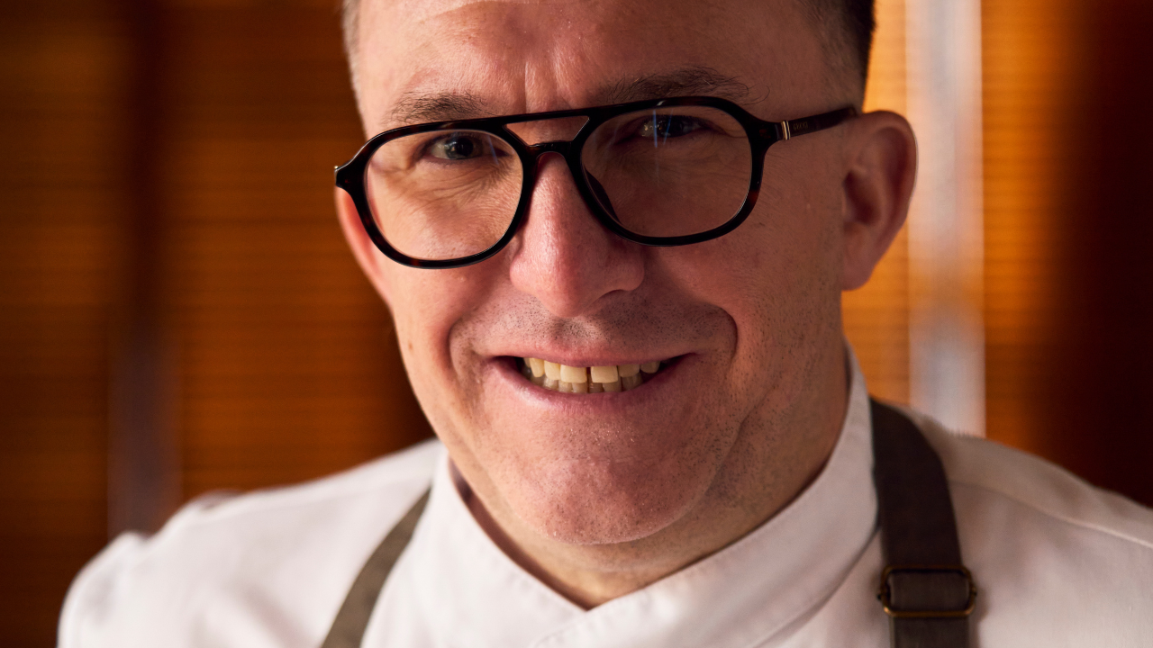 a man wearing glasses and a white shirt
