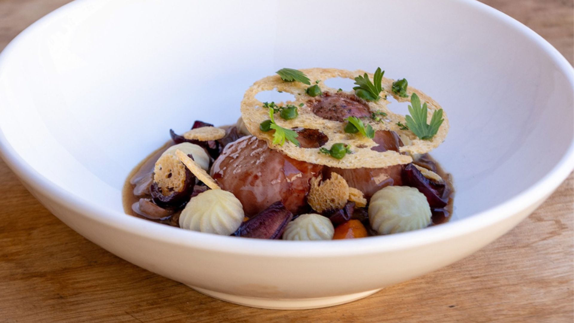 a bowl of soup with meat and vegetables