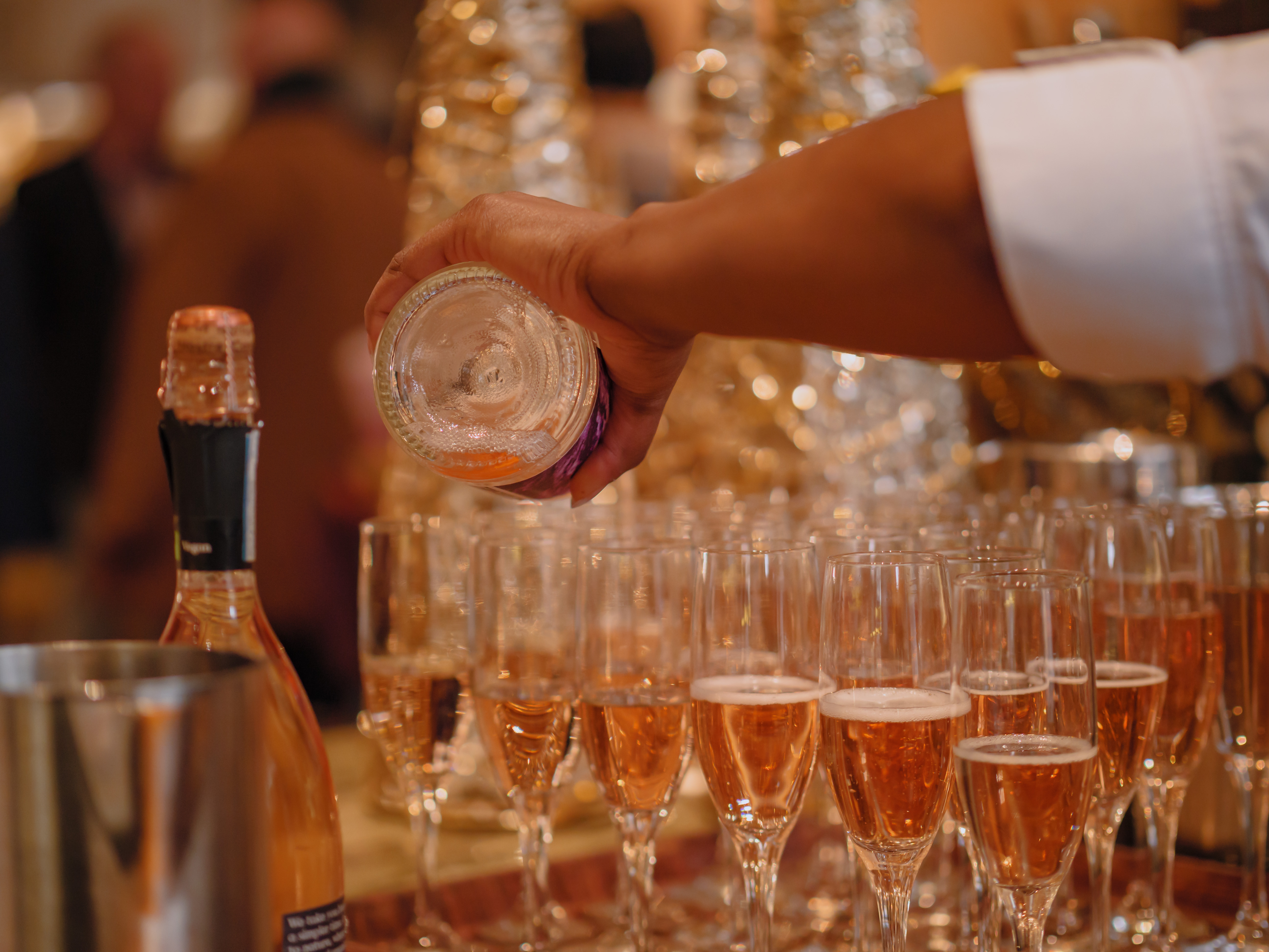 a person sitting at a table with wine glasses