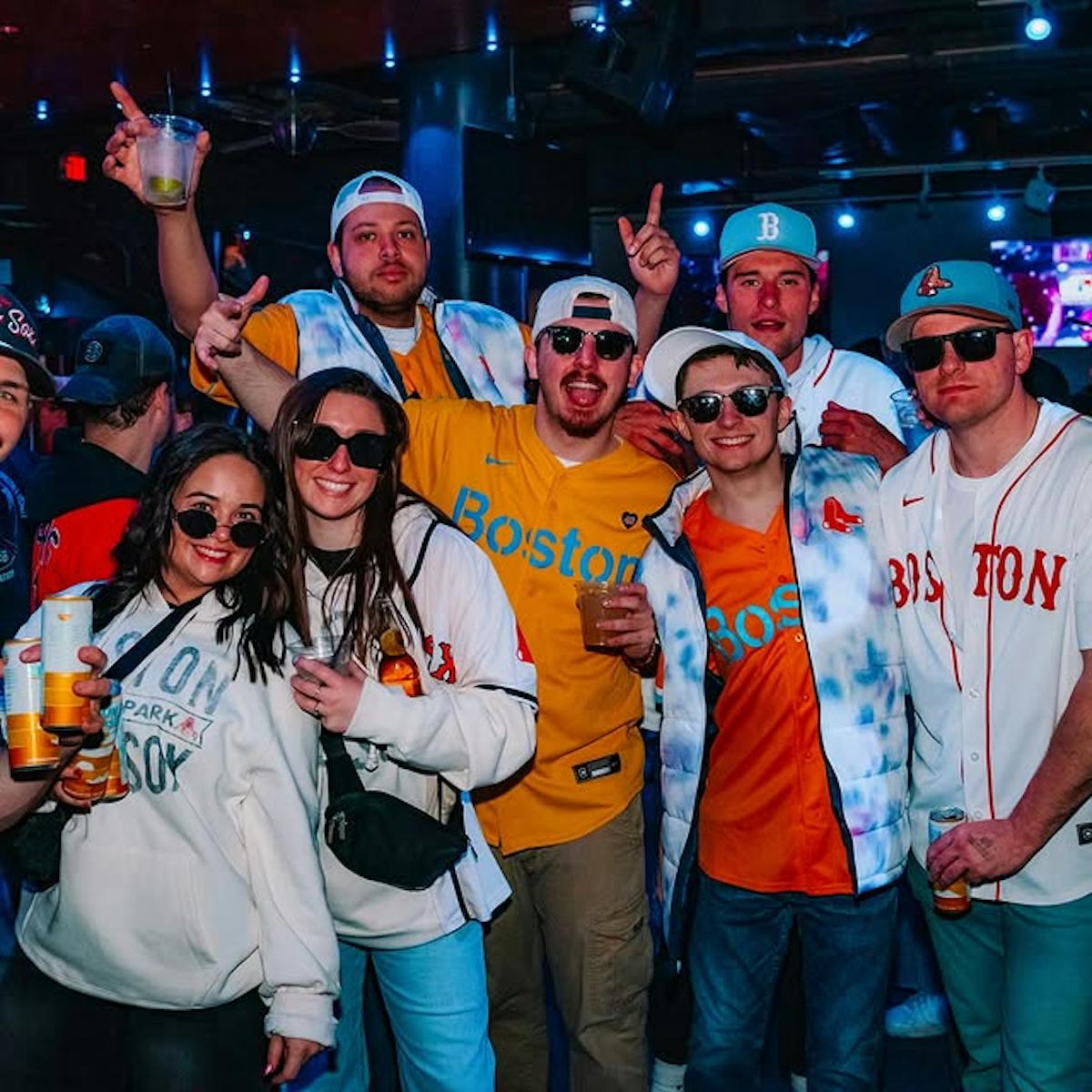 friends wearing Red Sox jerseys having fun