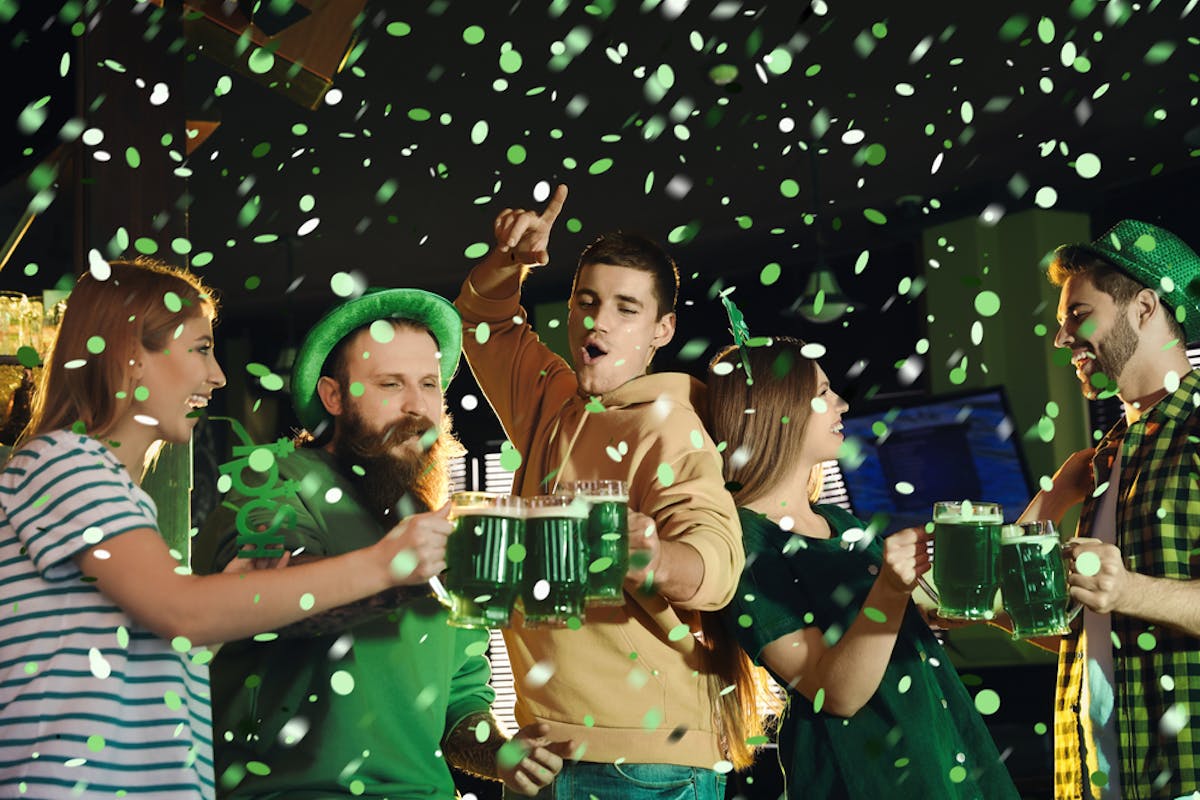 People celebrating St. Patrick's Day with green beer