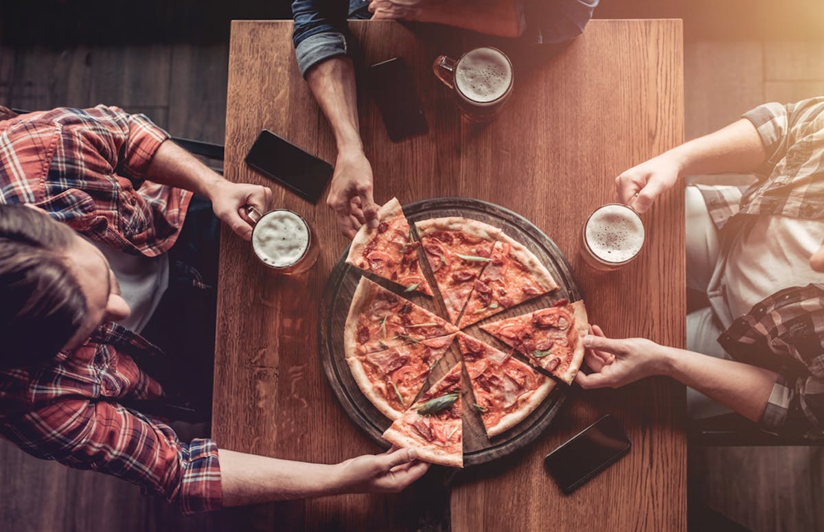 friends having pizza with beer