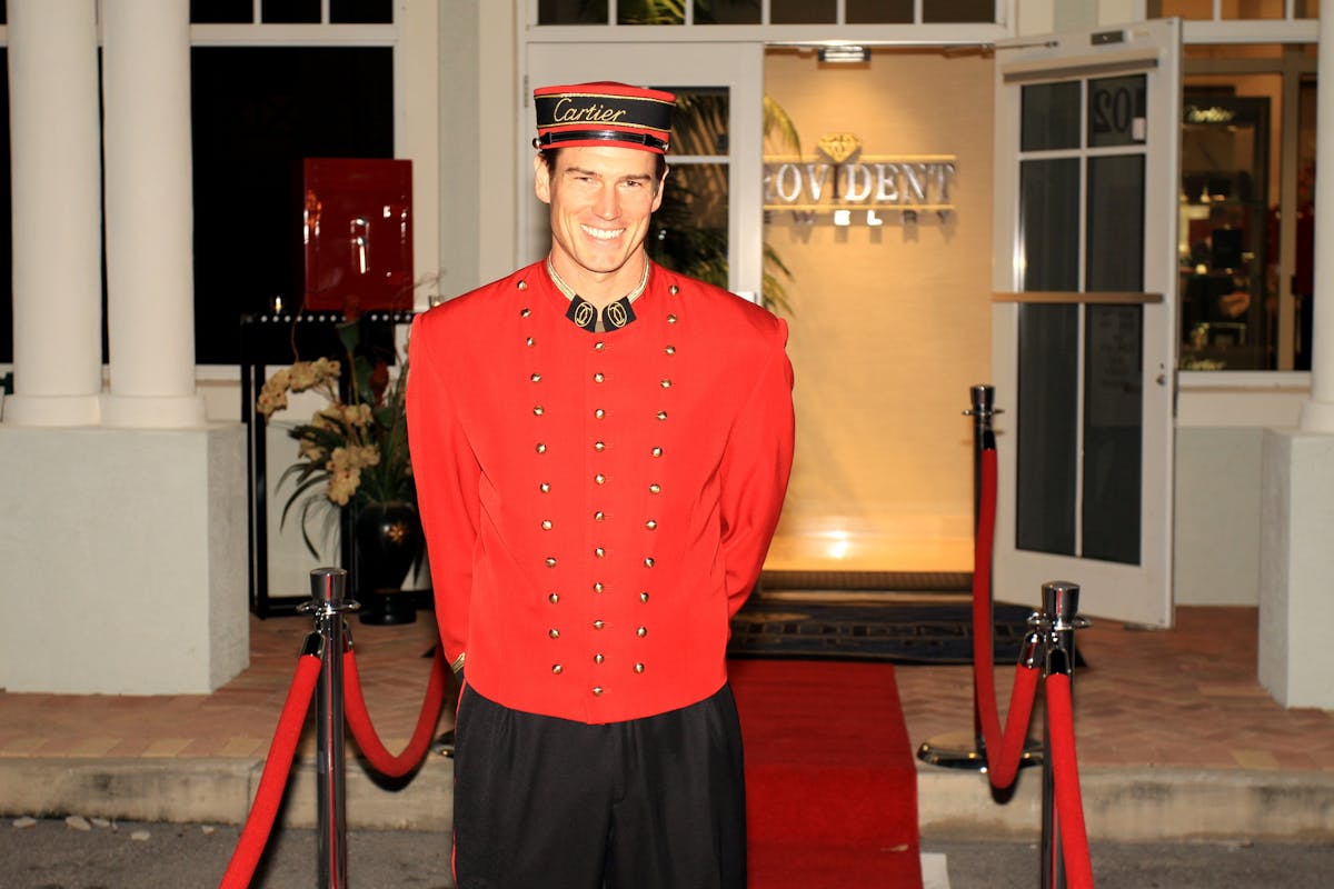 a person wearing a red jacket standing in front of a building