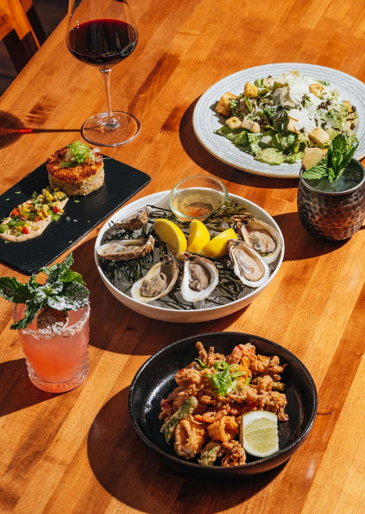 a plate full of food sitting on top of a wooden table