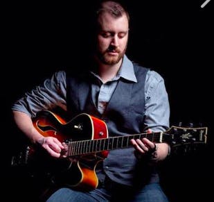 a man holding a guitar
