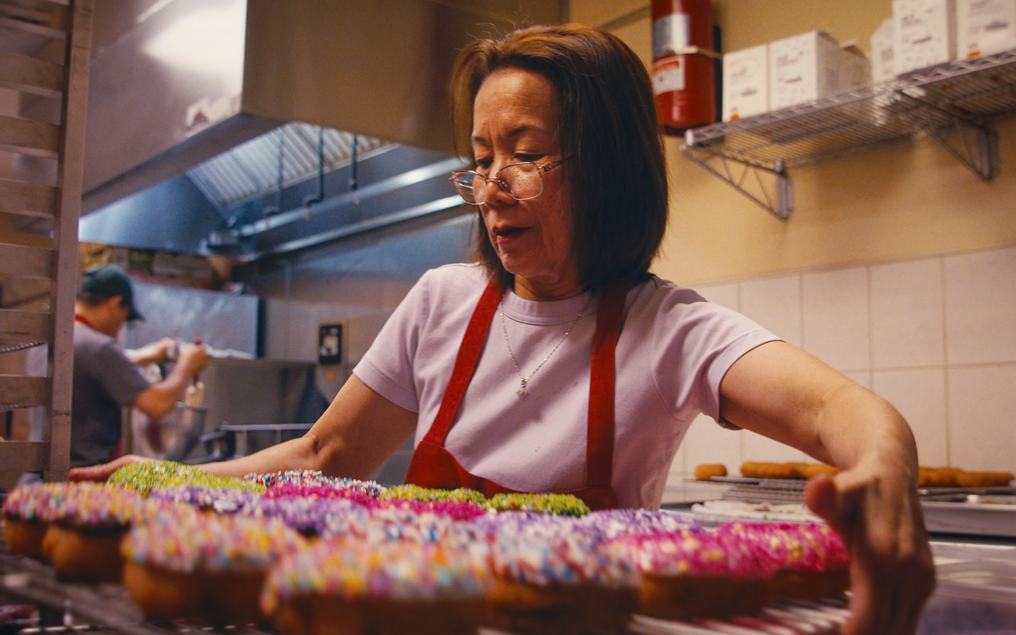 a person holding a tray of donuts