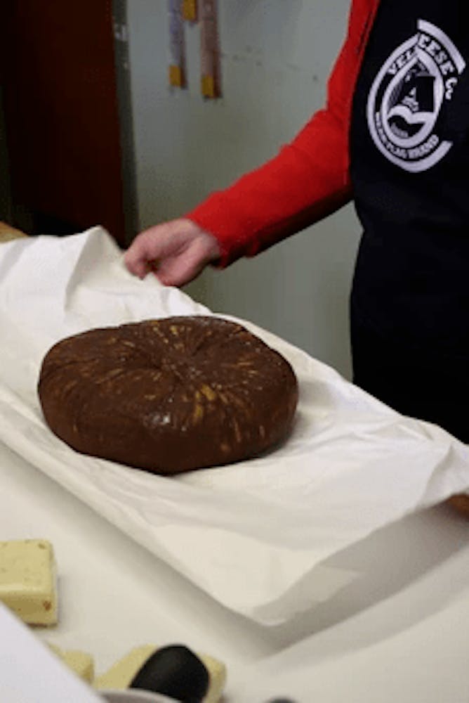 a hand holding a chocolate covered donut