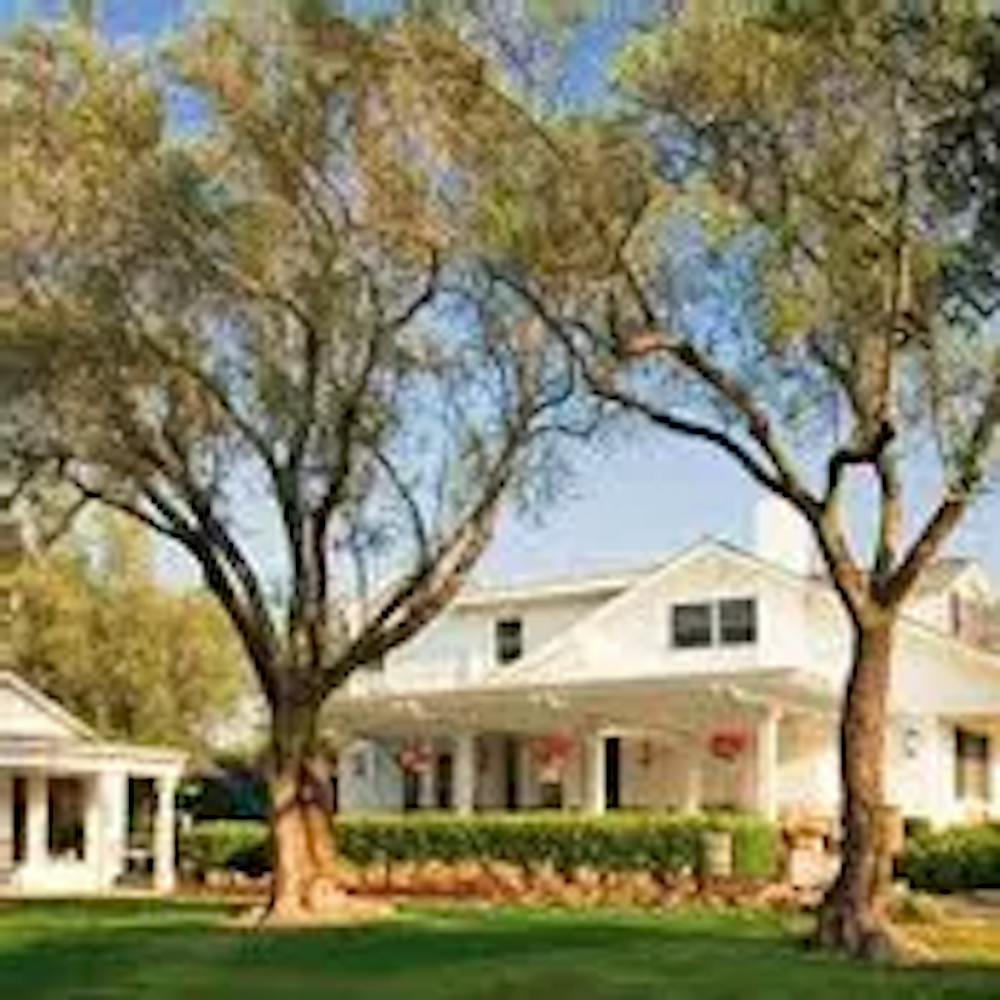 a tree in front of a house