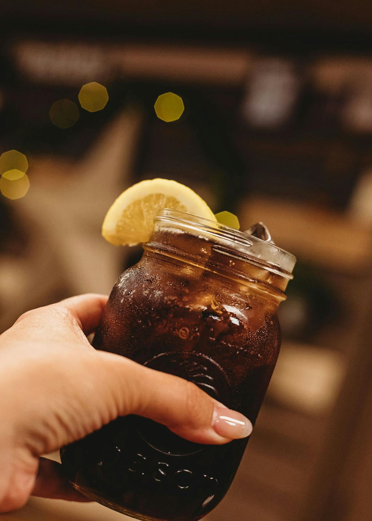 a hand holding a glass