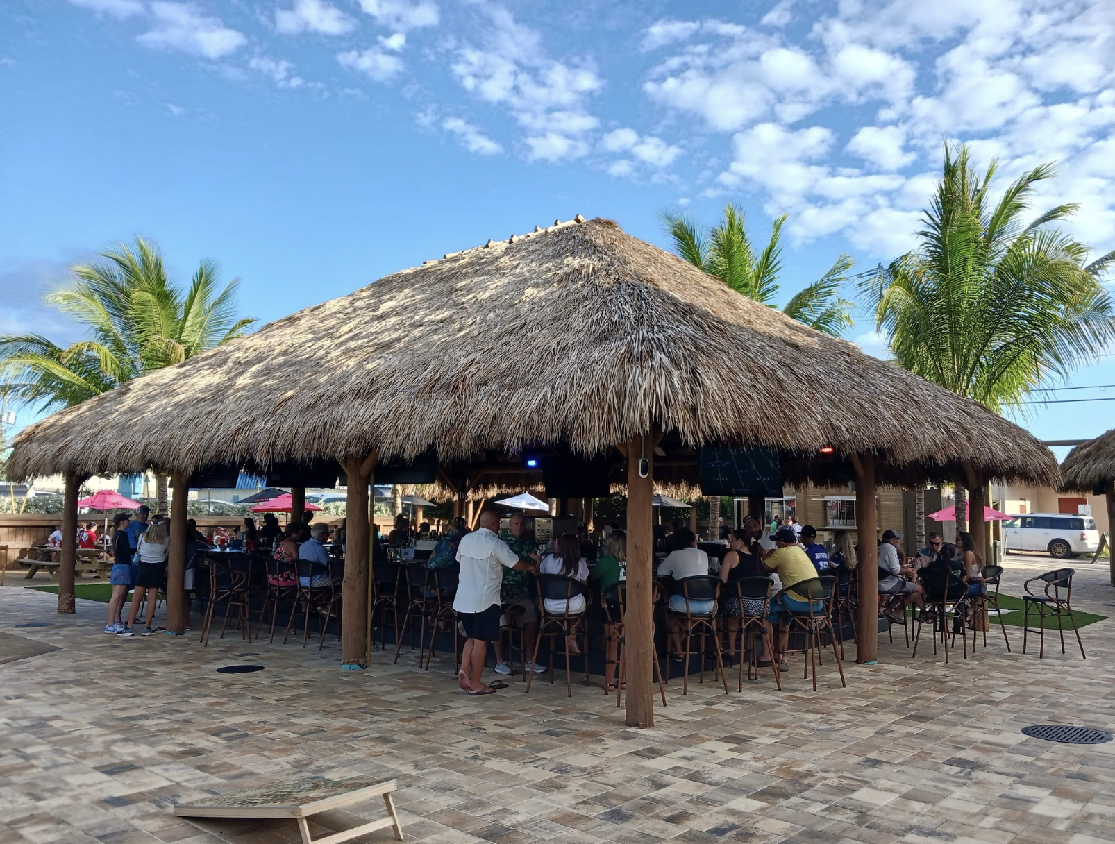 a group of people sitting at tables in a shelter