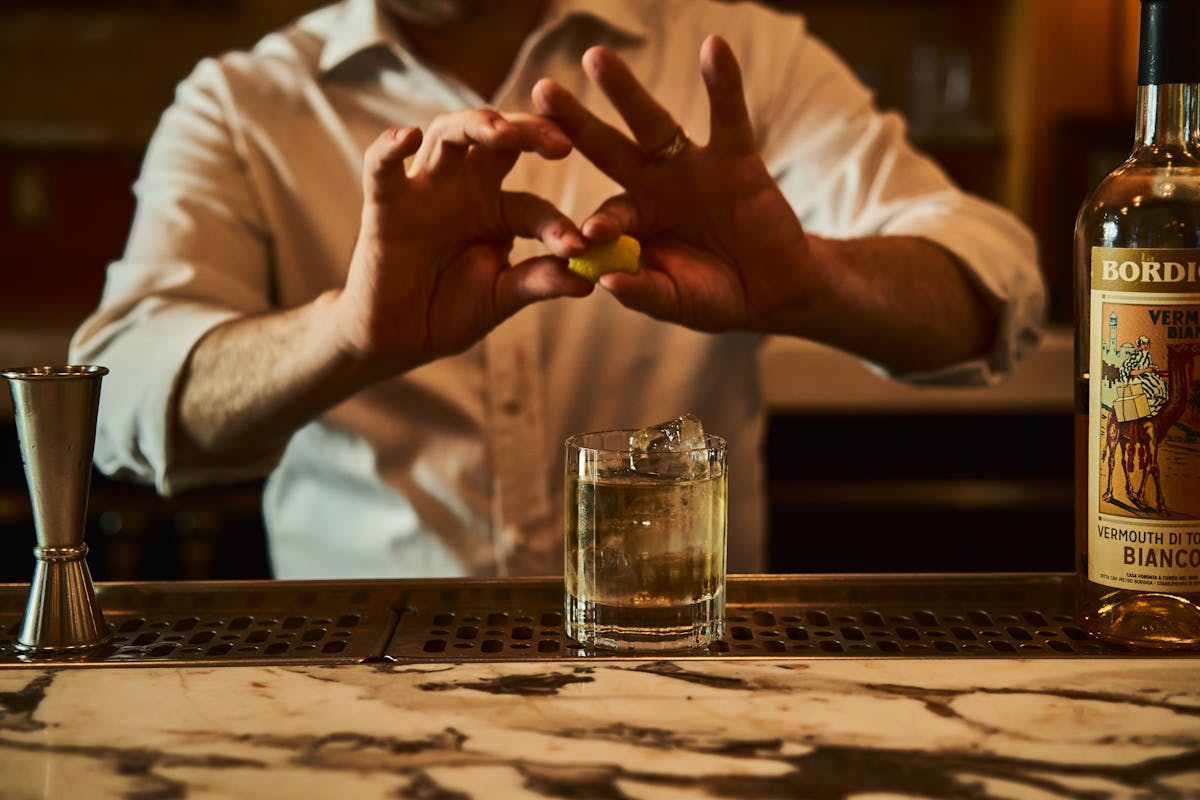 a person drinking a glass of wine