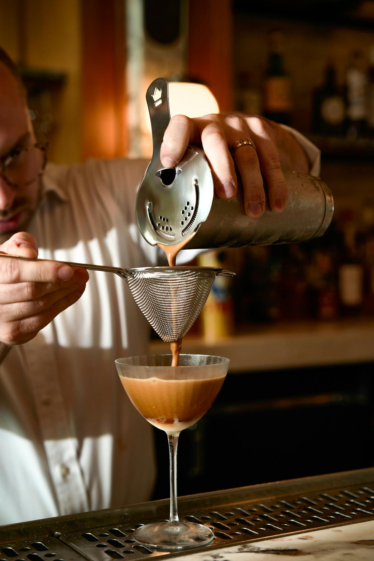 a close up of a person holding a wine glass