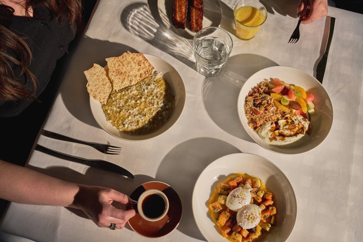 a person sitting at a table with a plate of food