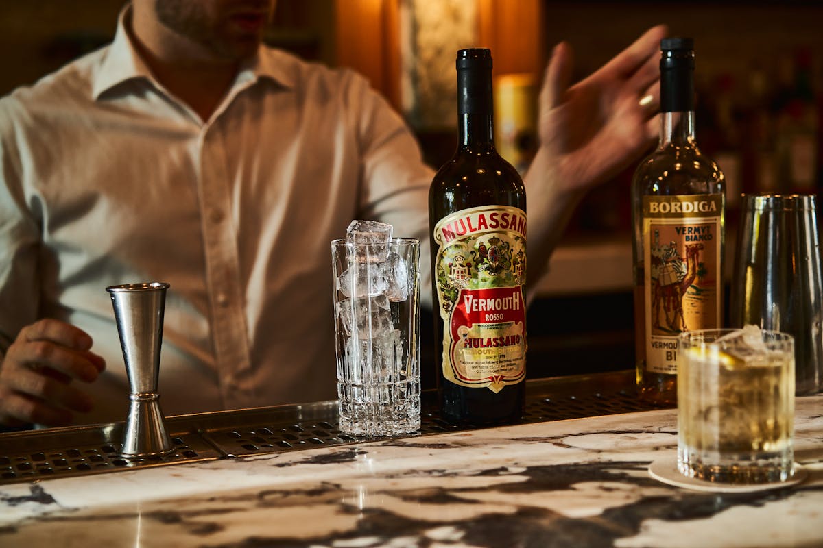 a bottle of wine and a glass of beer on a table