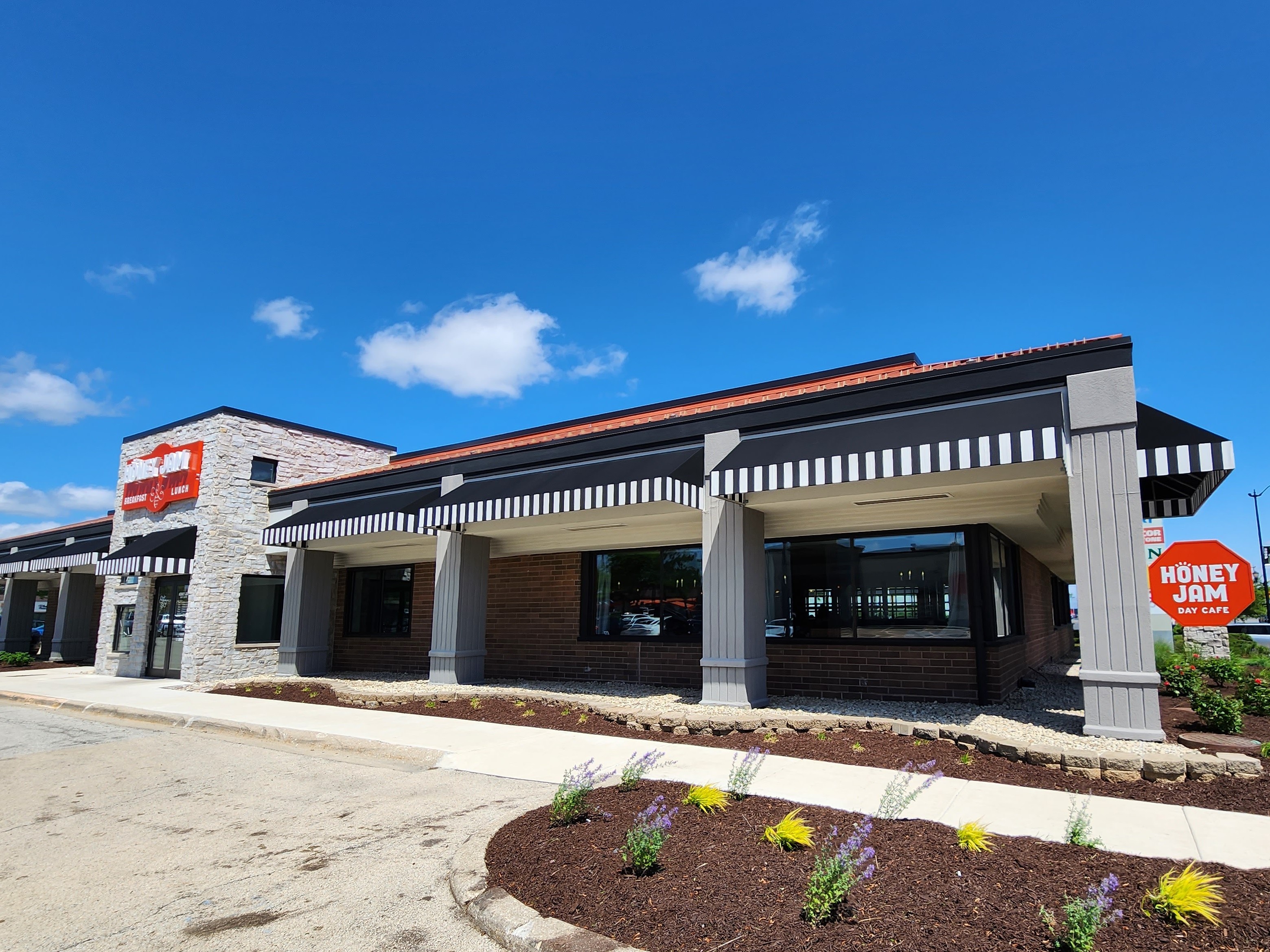 a house that has a sign on the side of a road
