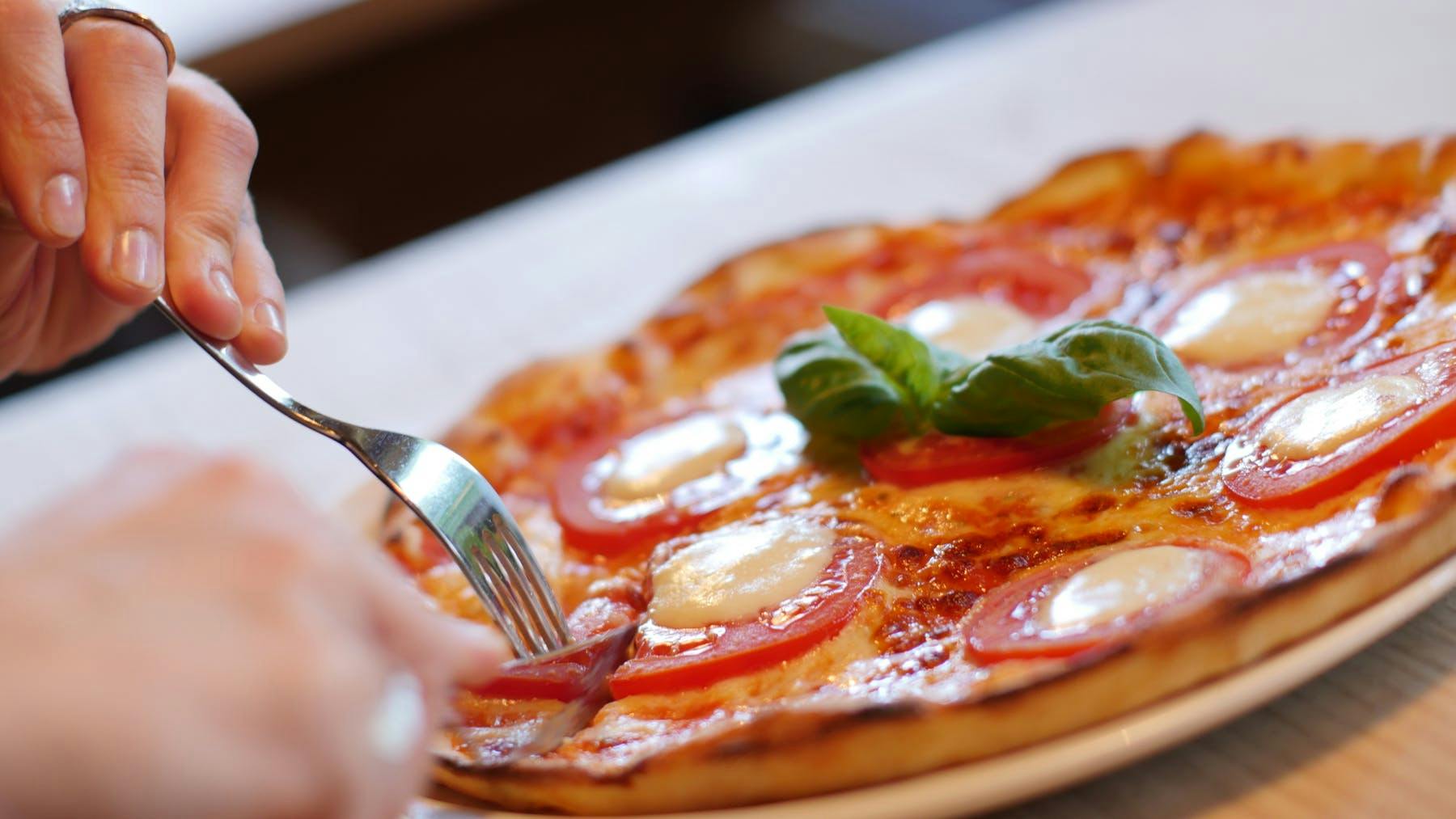 a close up of a plate of food with a slice of pizza