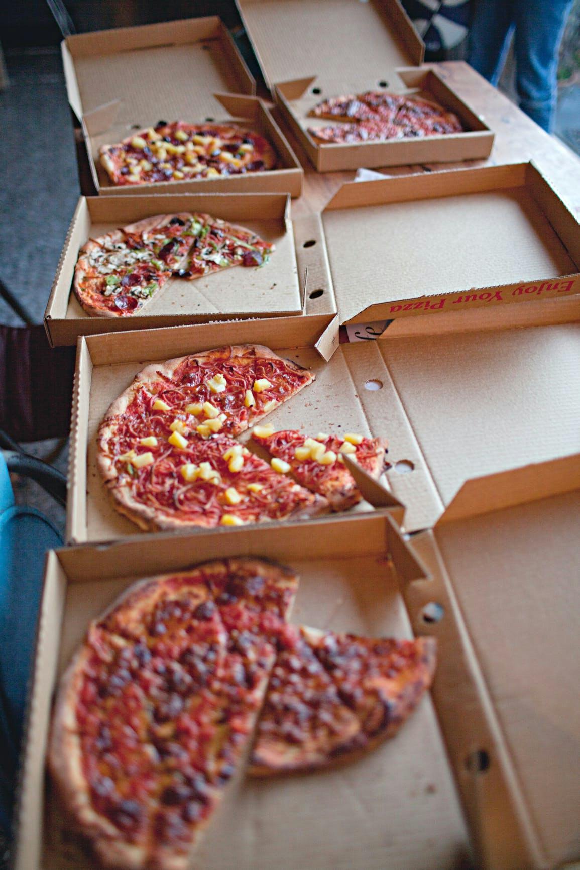 a pizza sitting on top of a wooden table