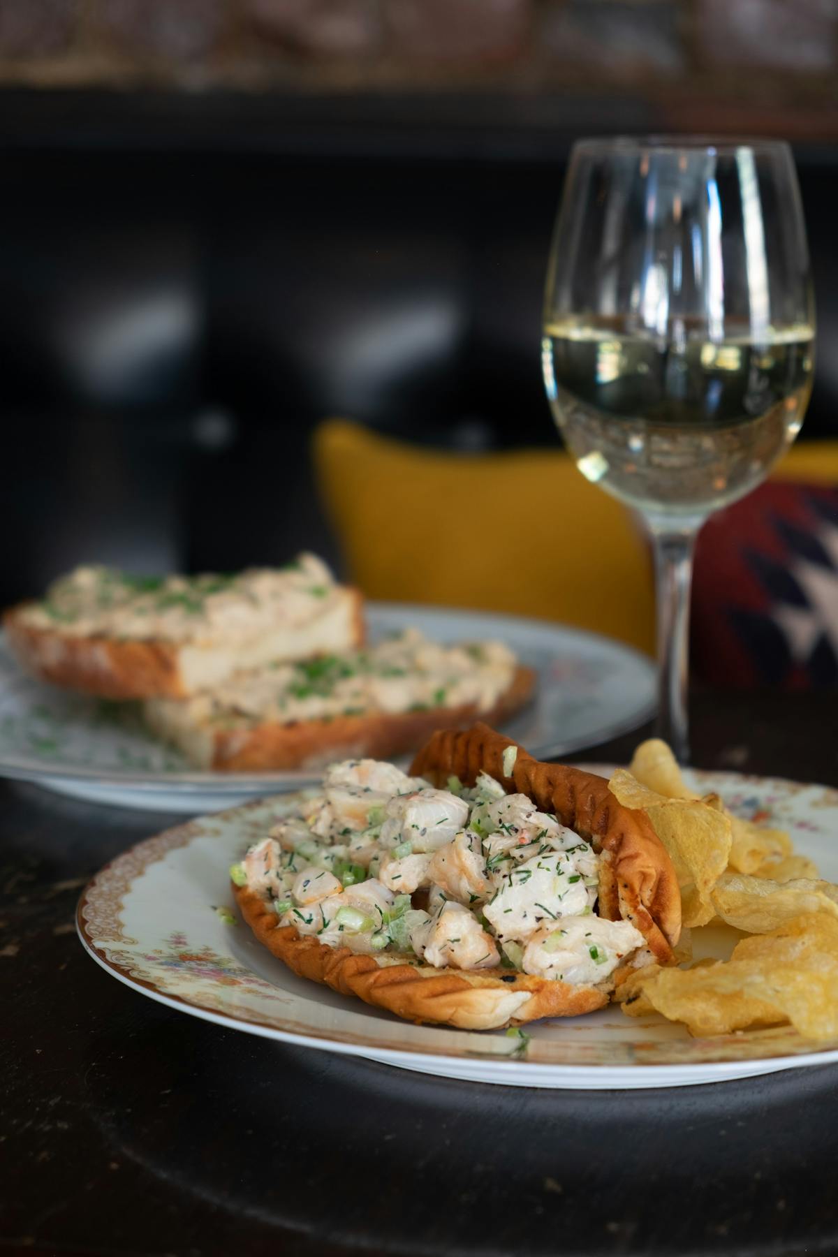 a plate of food and a glass of wine
