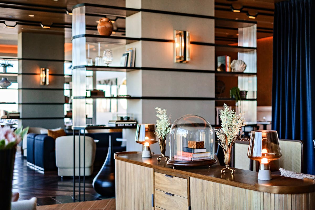 a room filled with furniture and vase on a table