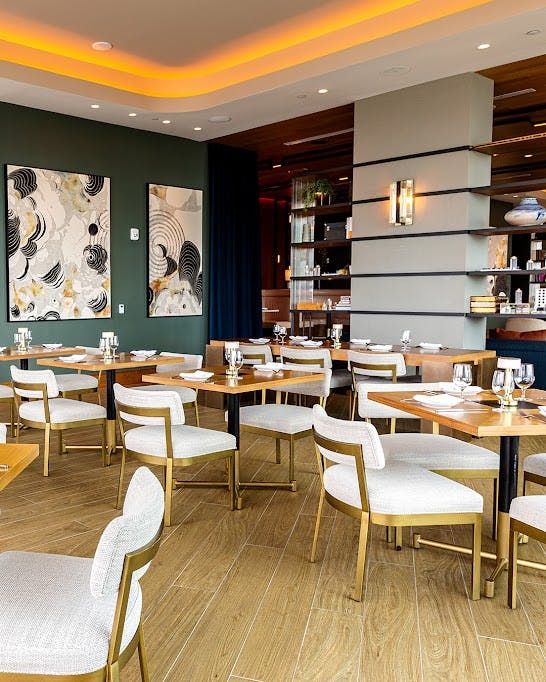 a living room filled with furniture and a table in a restaurant