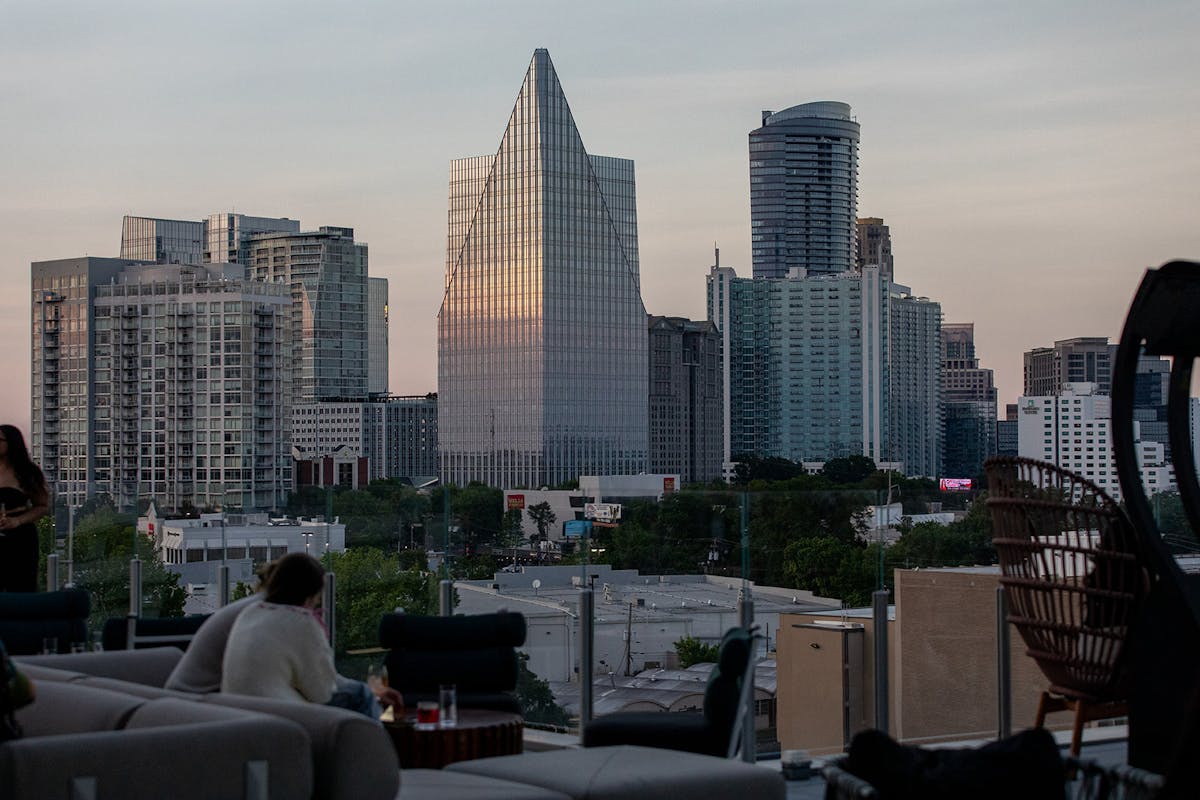 people viewing Atlanta skyline from Tesserae rooftop lounge
