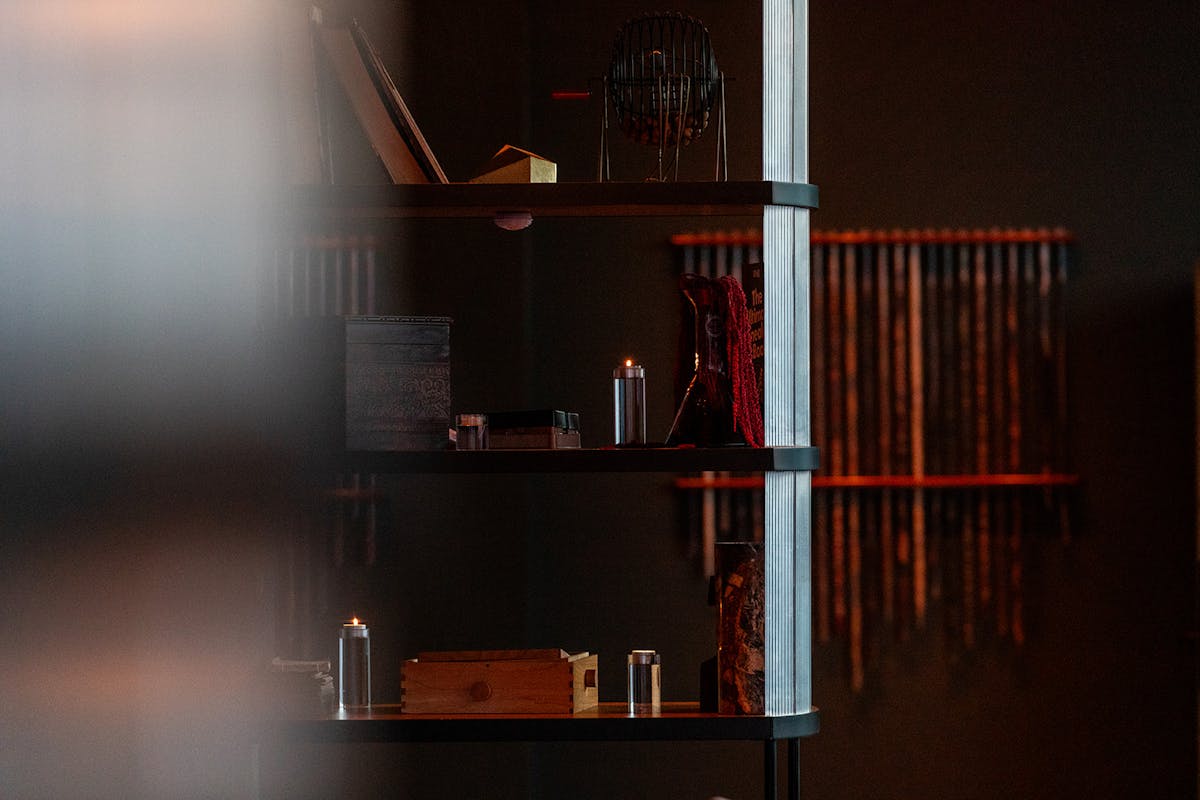 shelves with a candle and modern decor in tesserae restaurant