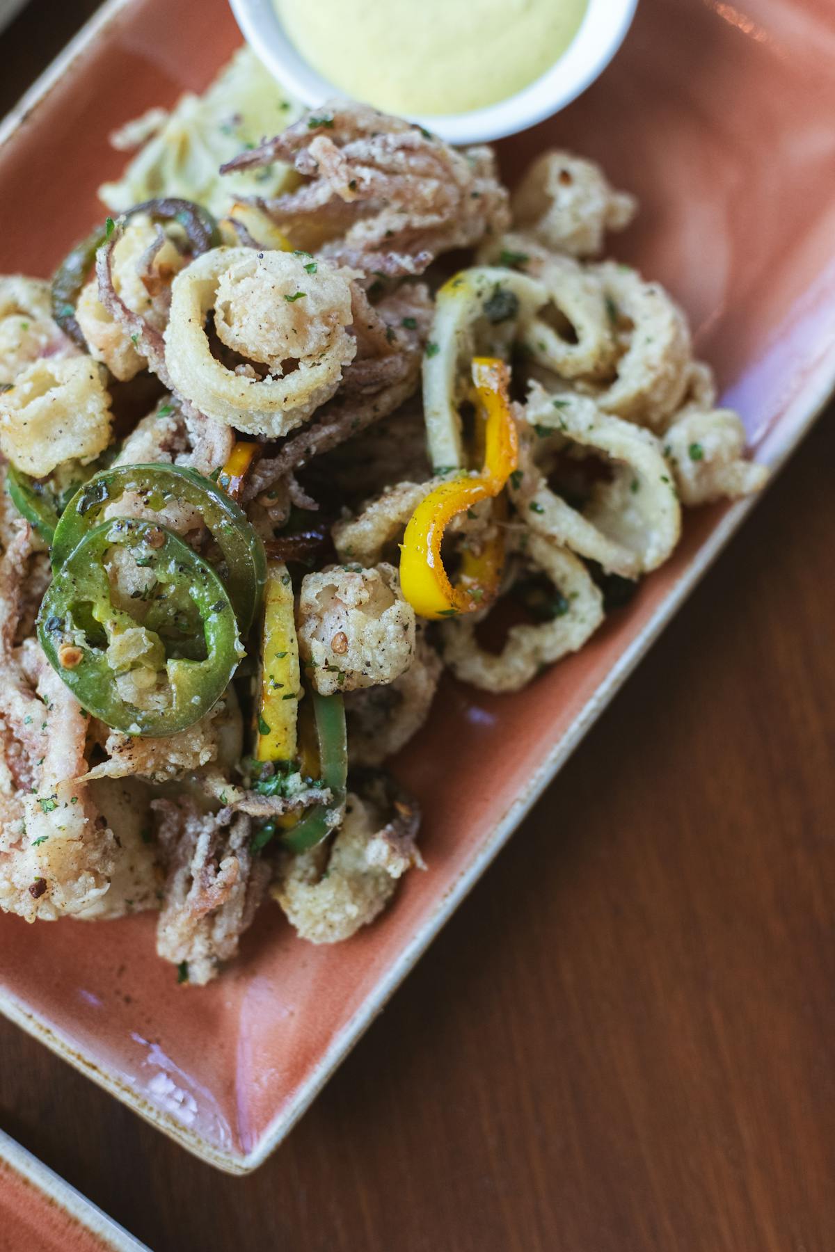 a closeup of a plate of fried calamari at tesserae